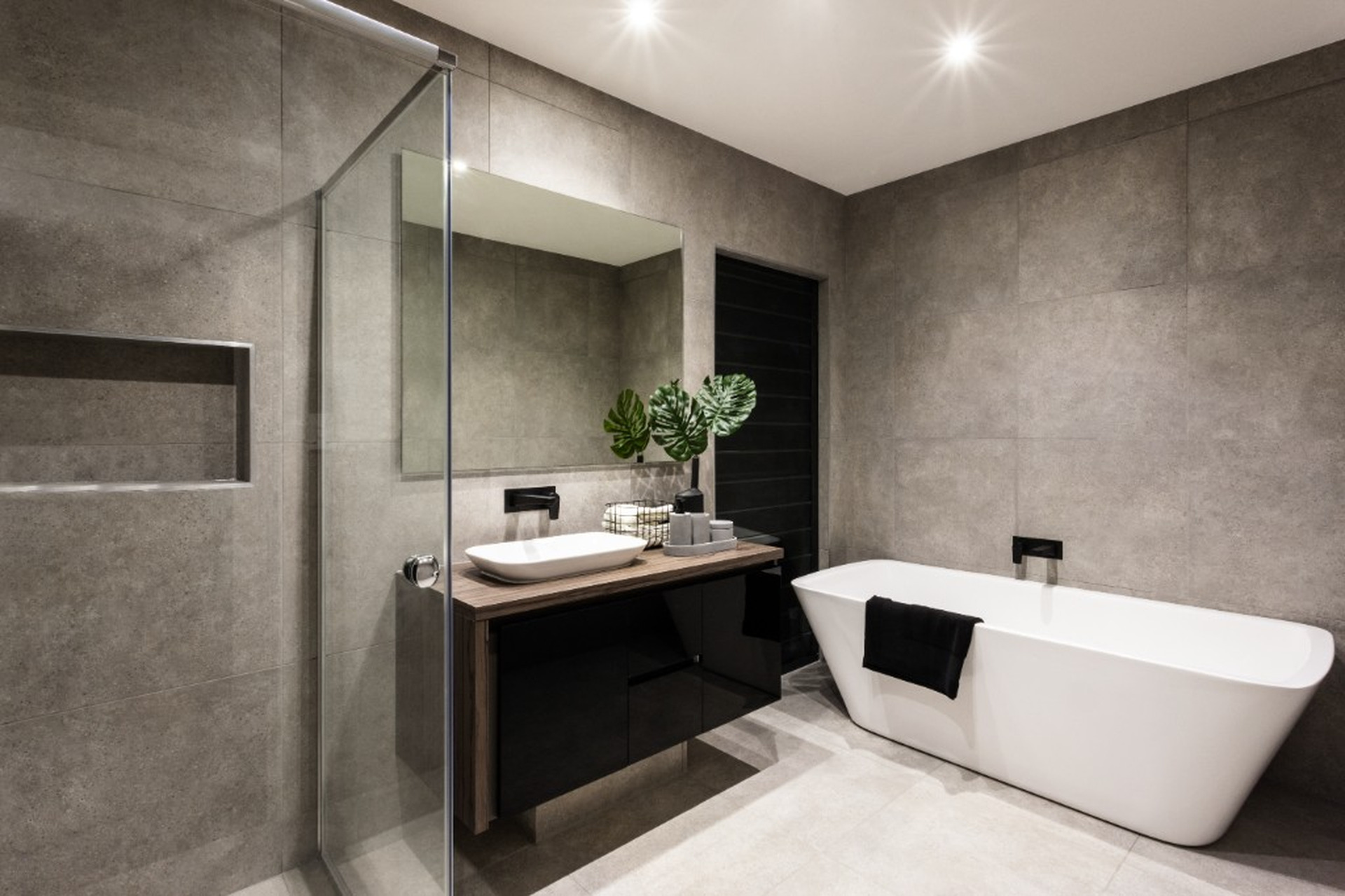 Modern grey tile bathroom with freestanding tub and floating vanity in Ottawa